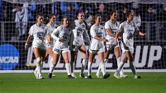 UNC huddles on the field.