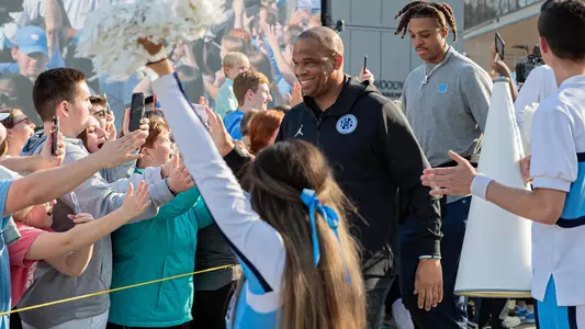 Hubert Davis smiles at fans at the Men's Basketball team send-off at the Smith Center on Wednesday