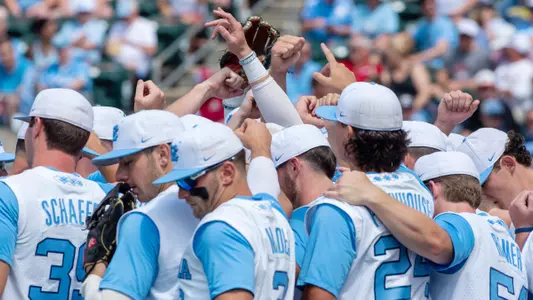 UNC huddles on the field.