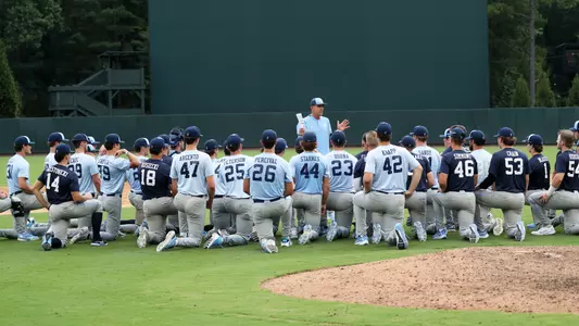 Coach Forbes (21) talks to the team after the scrimmage.