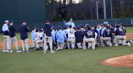 Coach Forbes (21) addresses the team following the scrimmage.