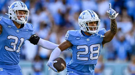 Junior defensive back Alijah Huzzie celebrates his interception against Syracuse on Saturday. UNC won 40-7.