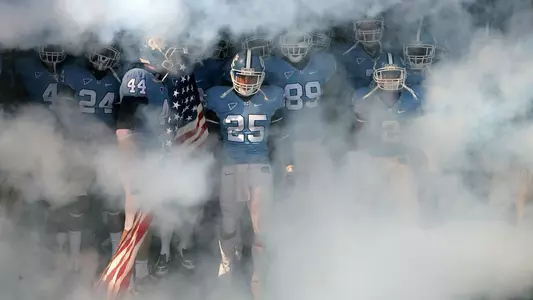 CHAPEL HILL, NC - NOVEMBER 22: Matt Merletti #25 of the North Carolina Tar Heels carries the American Flag as he leads his team before the start of their game against the North Carolina State Wolfpack at Kenan Stadium on November 22, 2008 in Chapel Hill, North Carolina. (Photo by Streeter Lecka/Getty Images) *** Local Caption *** Matt Merletti