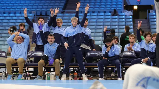The UNC bench reacts to a take down.
