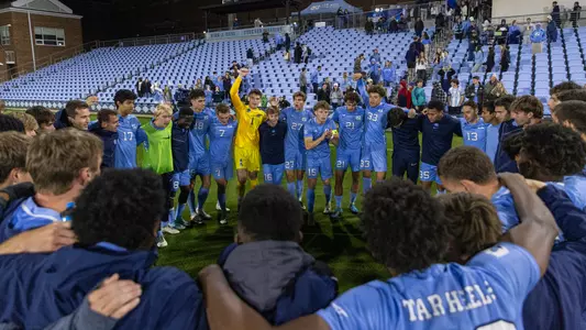 The Tar Heels huddle on the field.