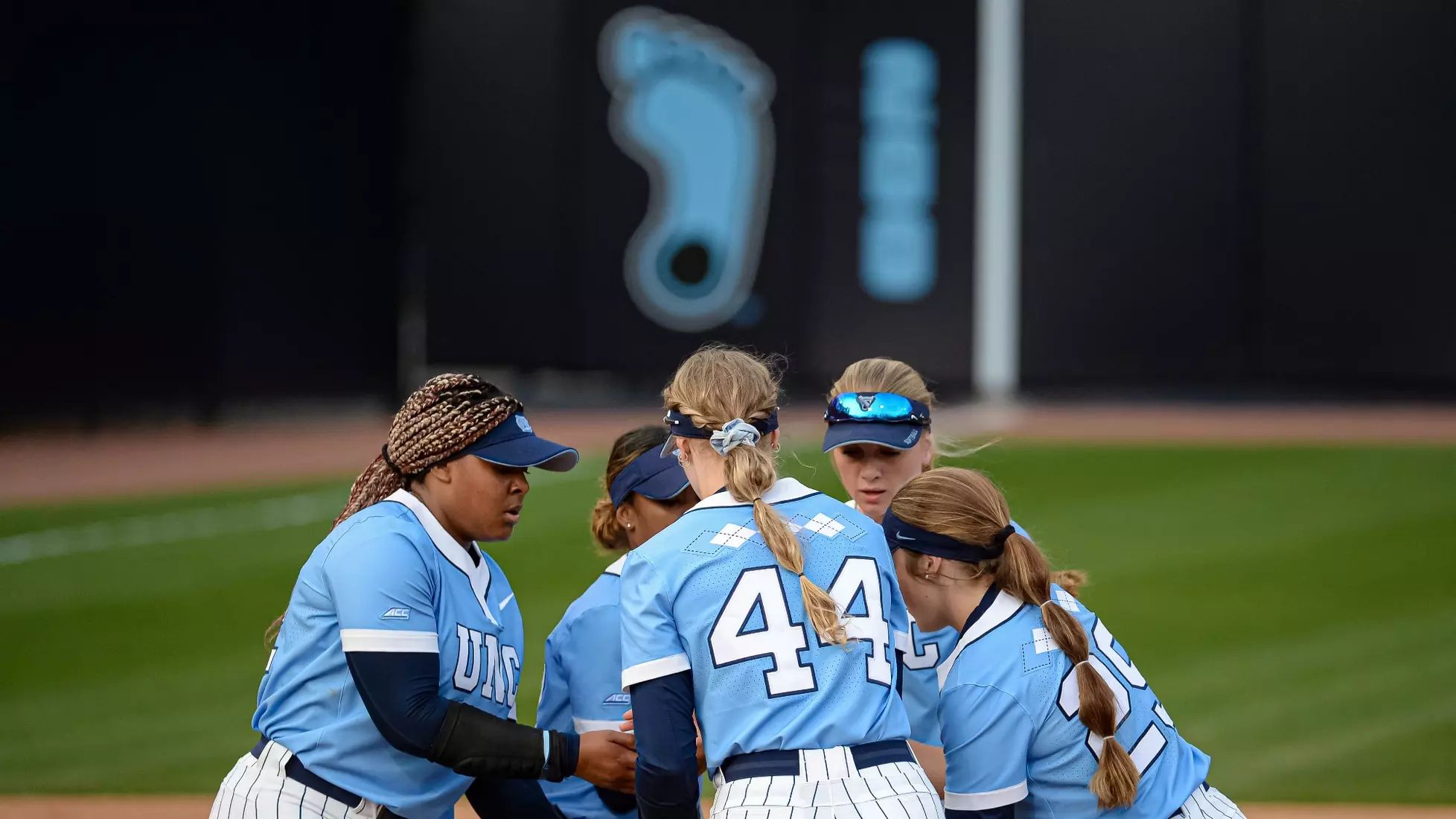 The Tar Heels huddle on the field.