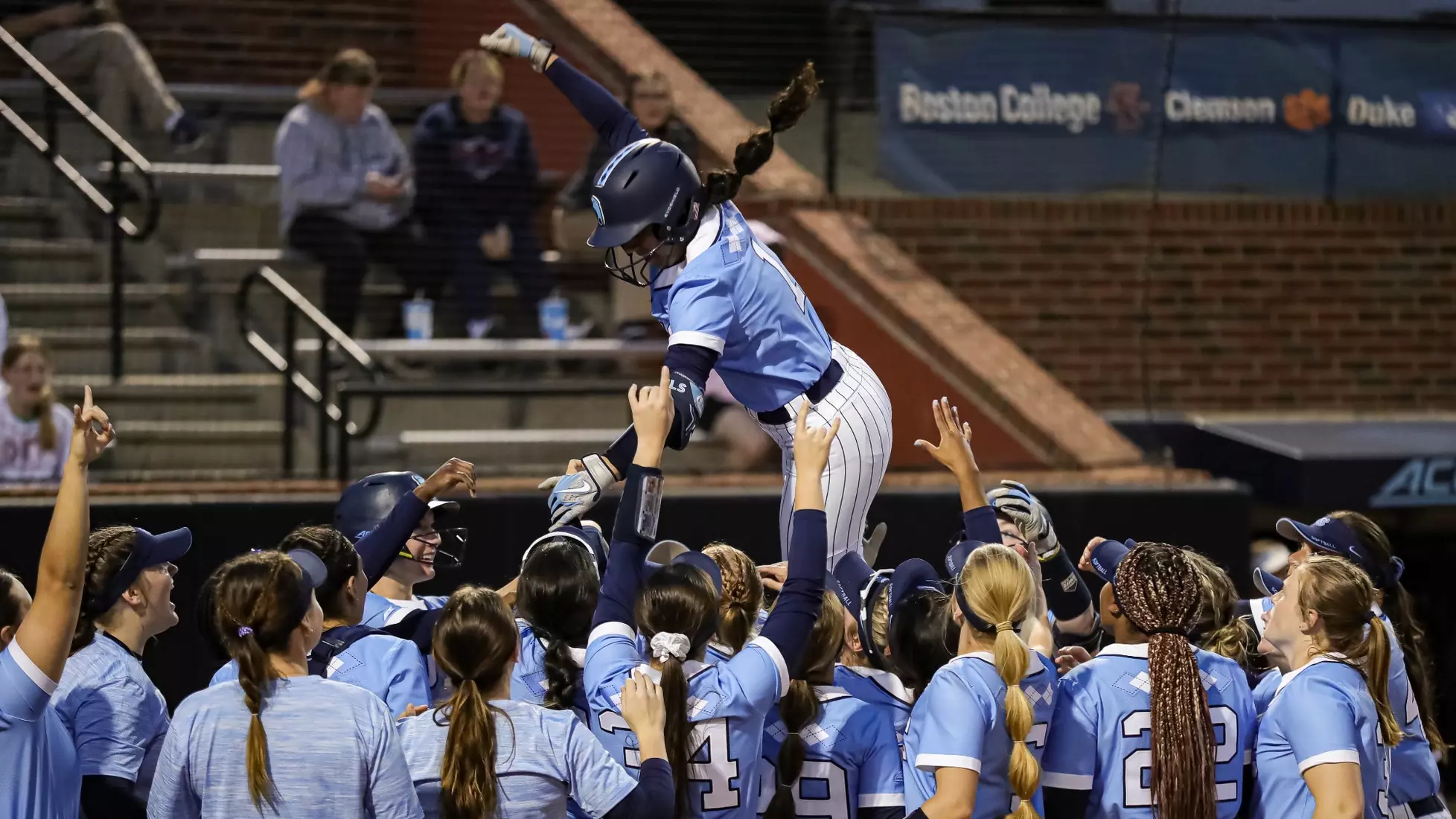 Kiersten Licea and the Tar Heels celebrate at home plate.