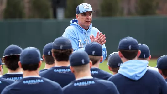 Coach Forbes (21) talks to the team.