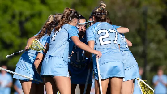 UNC huddles on the field.