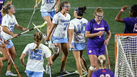 Reilly Casey, Alyssa Long, and the Tar Heels react to a goal against Clemson.