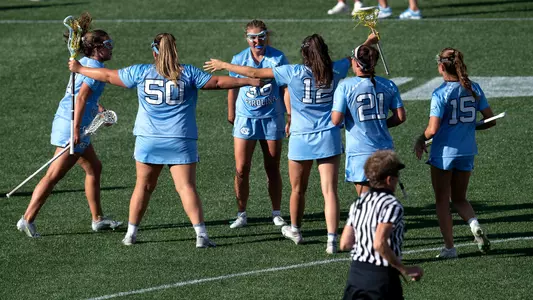 Caroline Godine, center, and the Tar Heels react to a score.
