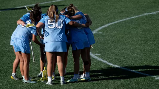 UNC huddles on the field.