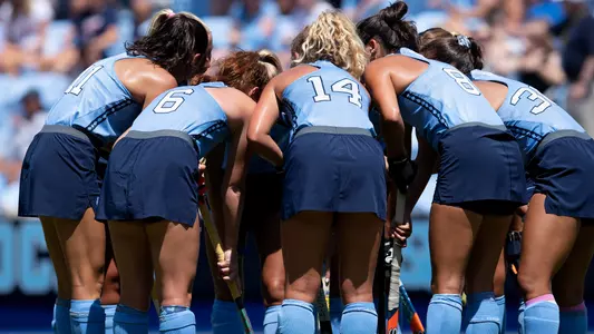 The Tar Heels huddle before taking a penalty corner.