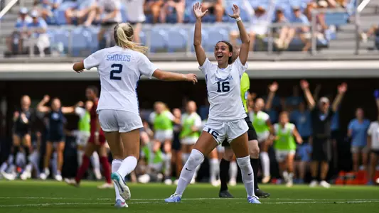 Evelyn Shores and Melina Rebimbas react to scoring against Southern California.