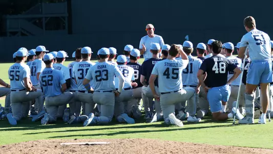 Coach Forbes (21) addresses the team.