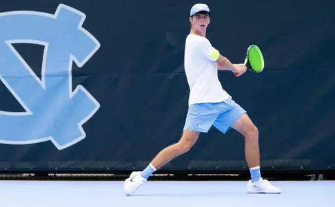 Sophmore Dennis Perumov looks to return a volley during the Tom Chewning Fall Invitational in Chapel Hill on Friday.