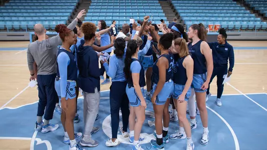 The Tar Heels huddle on the Carmichael Arena court.