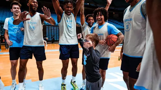 Colburn Dean with men's basketball team, Dream Team visit 2024
