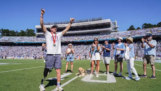 Carson Clough, who played lacrosse at UNC, is recognized for winning the silver in the men's PTS4 triathlon at the Paralympics in Paris, completing it in 1 hour and 47 seconds.