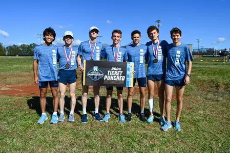 UNC Men's XC pose with "Ticket Punch Sign"