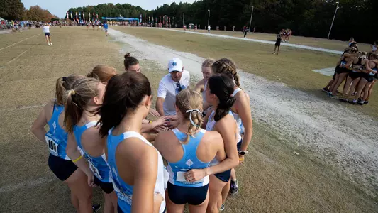 The women's cross country team huddles prior to competing at the ACC Championships in Cary Friday morning.