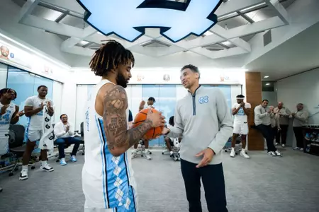 Marcus Paige presents RJ Davis with game ball