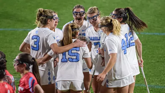 The Tar Heels huddle after scoring a goal.