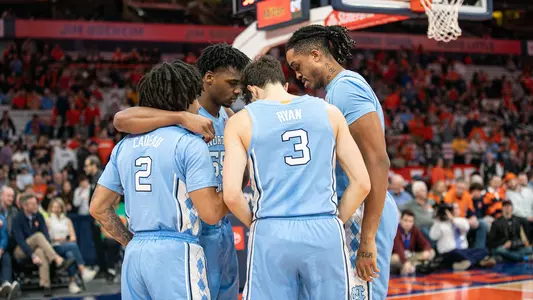 The Tar Heels huddle on the court.