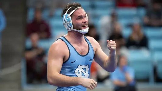 Graduate student Tyler Eischens smiles after clinching third place in 174-pounds during the ACC Championships at Carmichael Arena Sunday evening.