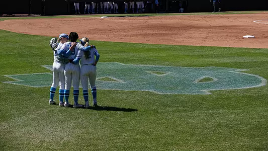 From left to right, junior Alex Coleman, freshman Sanaa Thompson and senior Carsyn Snead embrace in center field prior to their game against Georgia Tech on Sunday at Anderson Softball Stadium.