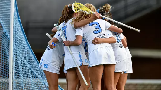 UNC huddles after scoring against Northwestern.
