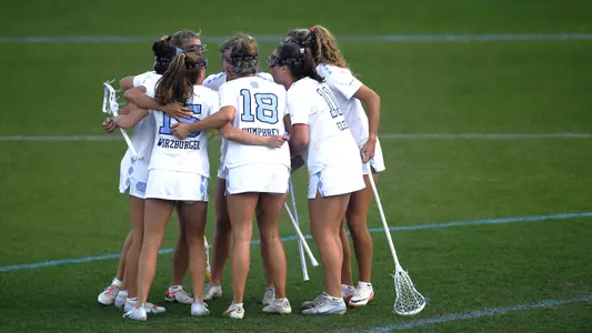 The Tar Heels huddle on the field.