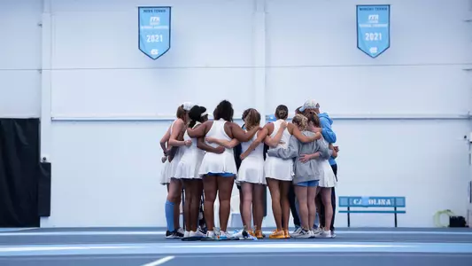 The Tar Heels huddle on the court.