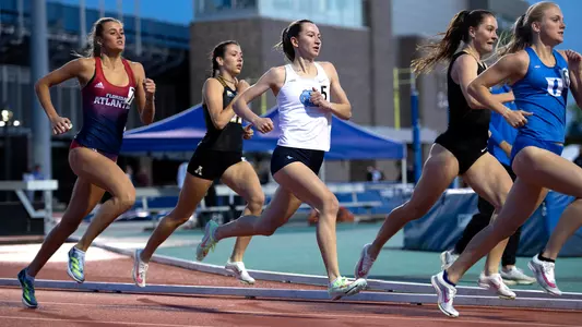 Junior Ella Auderset keeps pace with the pack during the 800-meter Invite at Morris Williams Stadium during the Duke Invitational on Friday night.
