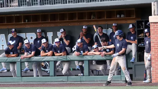Kane Kepley (27) and the Navy dugout.