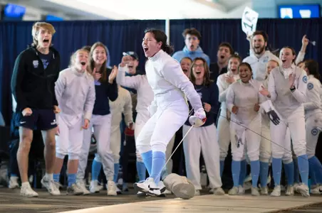 Freshman Dagny Johnson celebrates a sabre win against Duke at the Blue Zone Saturday morning.