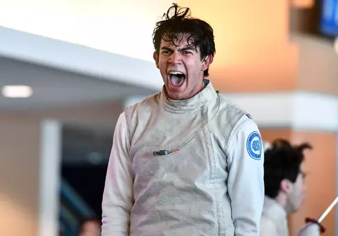 Sophomore Cristian Porras reacts to a win in foil against Duke at the Blue Zone Saturday morning.