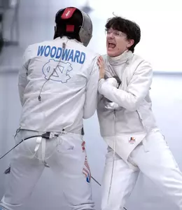 Freshman Finn Buchmann celebrates with teammate freshman Connor Woodward after scoring a win against NYU during the Miller Invitational at Eddie Smith Field House Sunday.