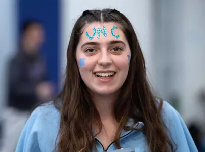 Freshman Mariasole Capellua decorated her face to support the men’s team during the Miller Invitational Sunday at Eddie Smith Field House.