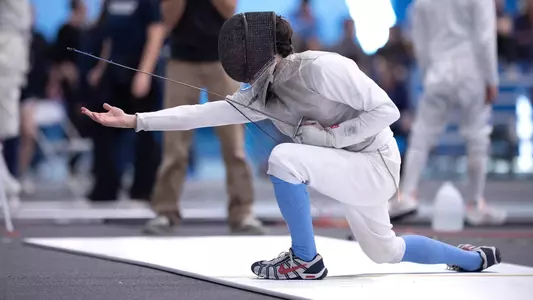 Sophomore Alexander Sichitiu celebrates a win in foil against John Hopkins during the Miller Invitational at Eddie Smith Field House Sunday afternoon.