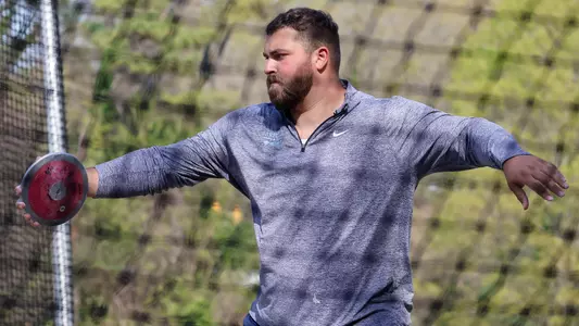 Graduate student Tommy Kitchell warms up before competing in the discus throw during the Raleigh Relays at Paul Derr Track in Raleigh.