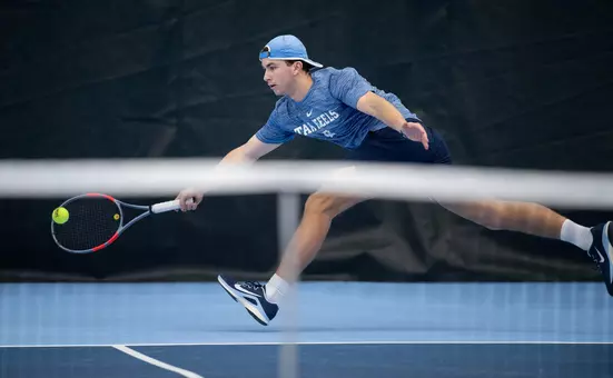 Freshman Ian Mayew reaches for a volley against UNC Asheville at Chewning Tennis Center Tuesday.