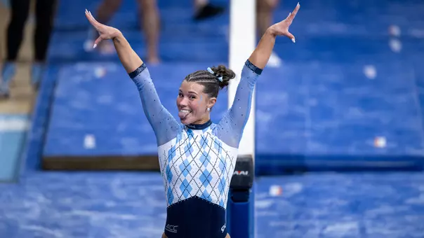Sophomore Regan McBride reacts to her landing off of her balance beam performance during competition against Nebraska and Penn State at Carmichael Arena Friday.