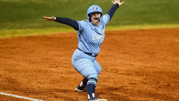Graduate student Michele Tarpey reacts to being safe at third base against Elon at Hunt Softball Park in Elon Wednesday.