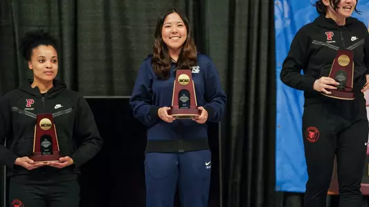 Dagny Johnson Poses On the Podium with her trophy