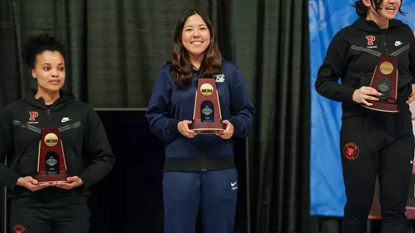 Dagny Johnson Poses On the Podium with her trophy