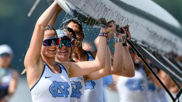 UNC rowers lift their boat out of the water after their race during the Lake Wheeler Invitational at Lake Wheeler in Raleigh Saturday.