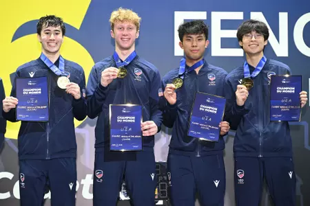 Peter Bruk Wins World Champion and poses on podium