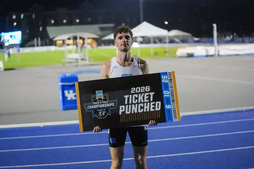 Tomer Tarragano Qualifies For NCAA Championships In Men’s 10,000m posing with the ticket