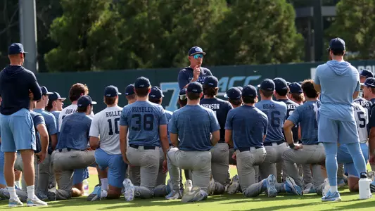 Coach Forbes (21) addresses the team after the scrimmage.